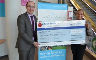 eand hands over a charity chequenoch ev