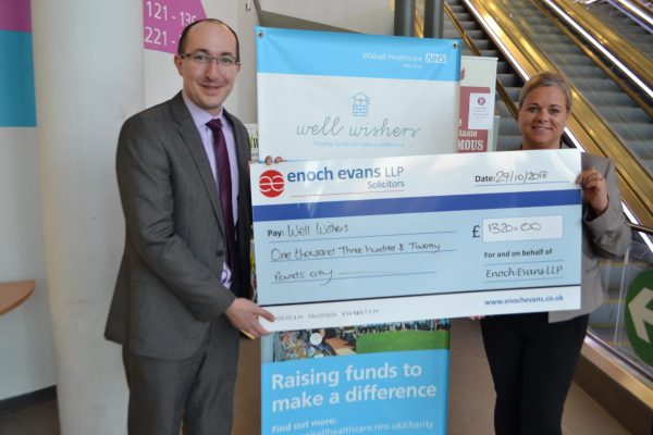 eand hands over a charity chequenoch ev