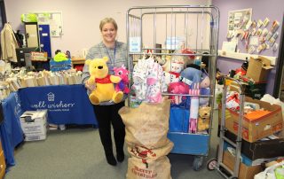 Fundraising manager with toys and gifts donated