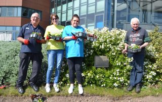 Volunteers plant the Well Wishers flowerbed