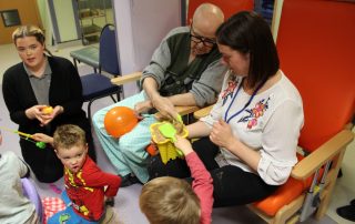 children and elderly patients enjoying a seaside party