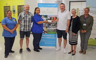 Handing over the cheque to staff from the chemotherapy unit