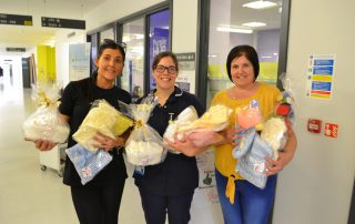 Aimee and her mum hand over items for bereaved parents