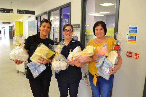 Aimee and her mum hand over items for bereaved parents