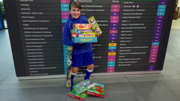 Schoolgirl Daisy with her toys' donation