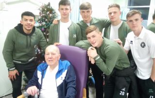 Saddlers fan John with favourite player Josh Gordon and his team mates