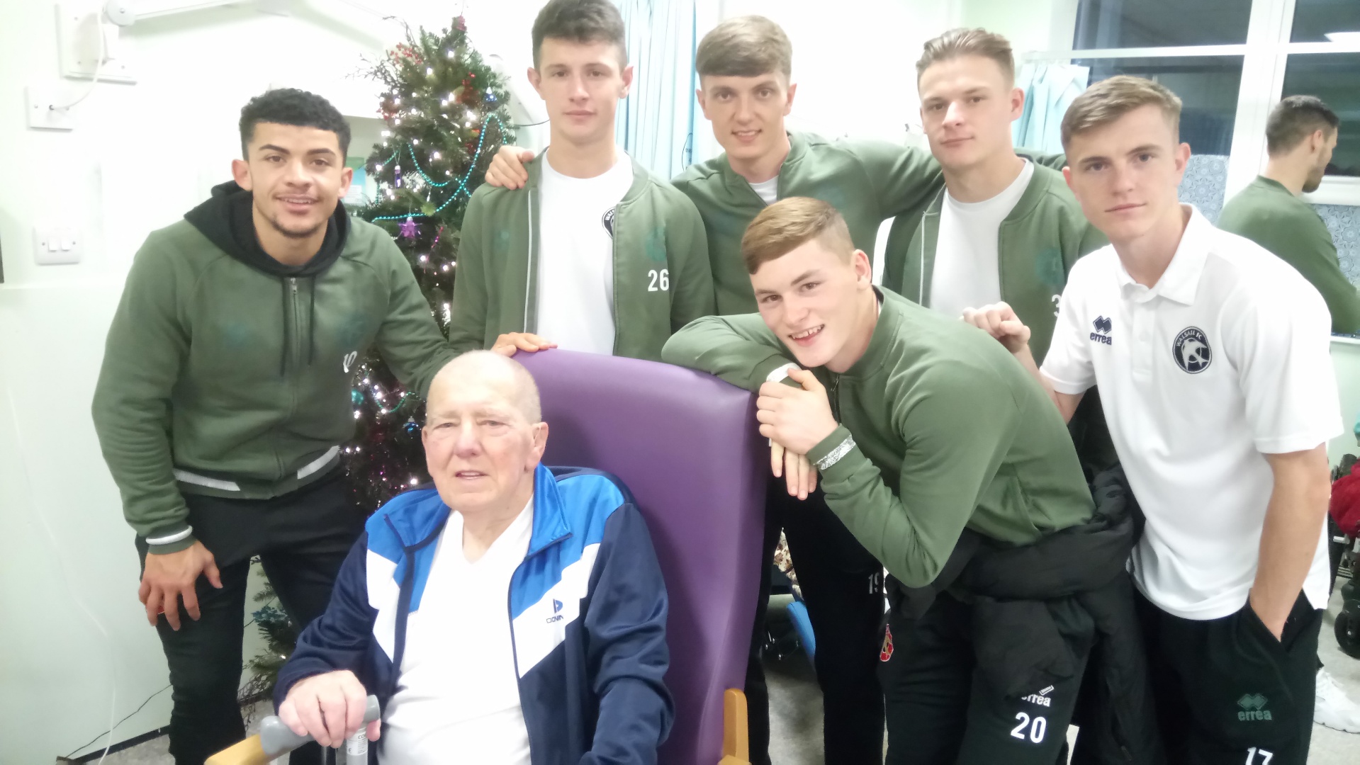 Saddlers fan John with favourite player Josh Gordon and his team mates