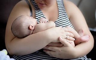 mother holding baby