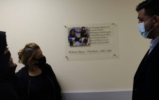 Areema's family look at the memorial plaque on AMU