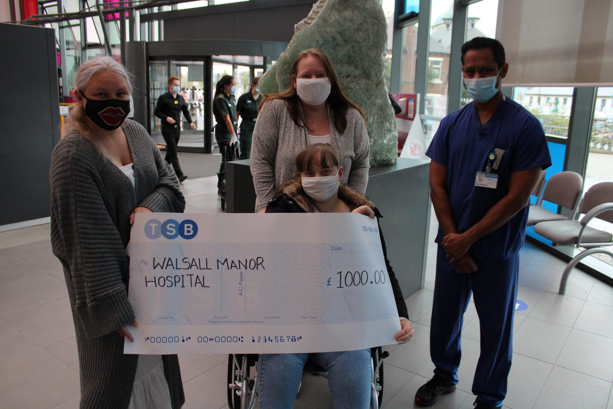 Ellie and her family have handed cheques over to the hospital