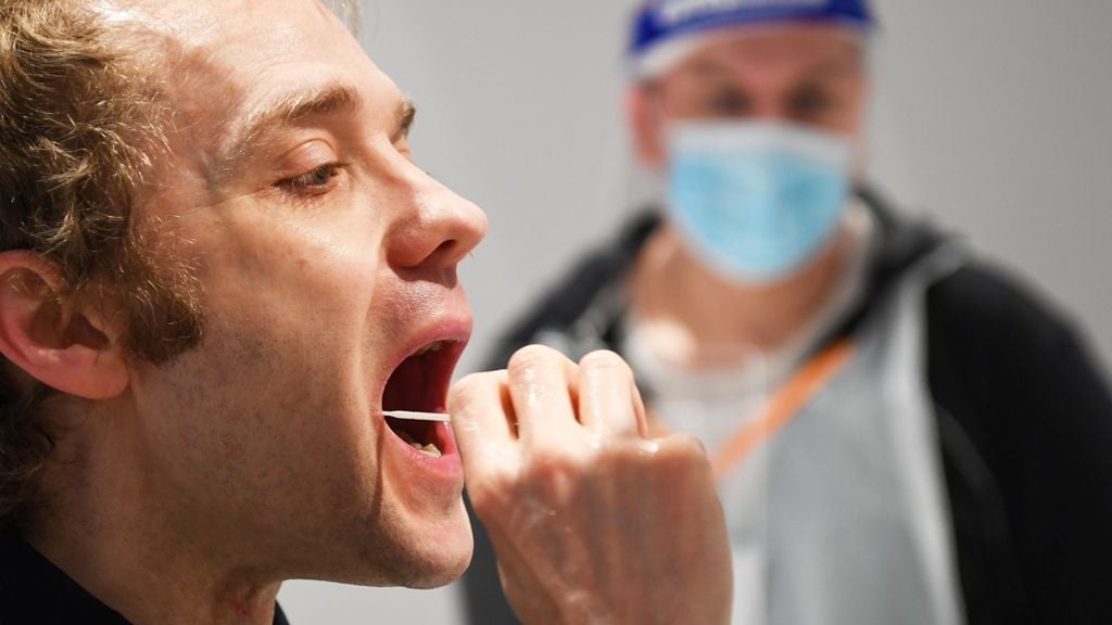 Man taking a swab for a lateral flow Covid-19 test