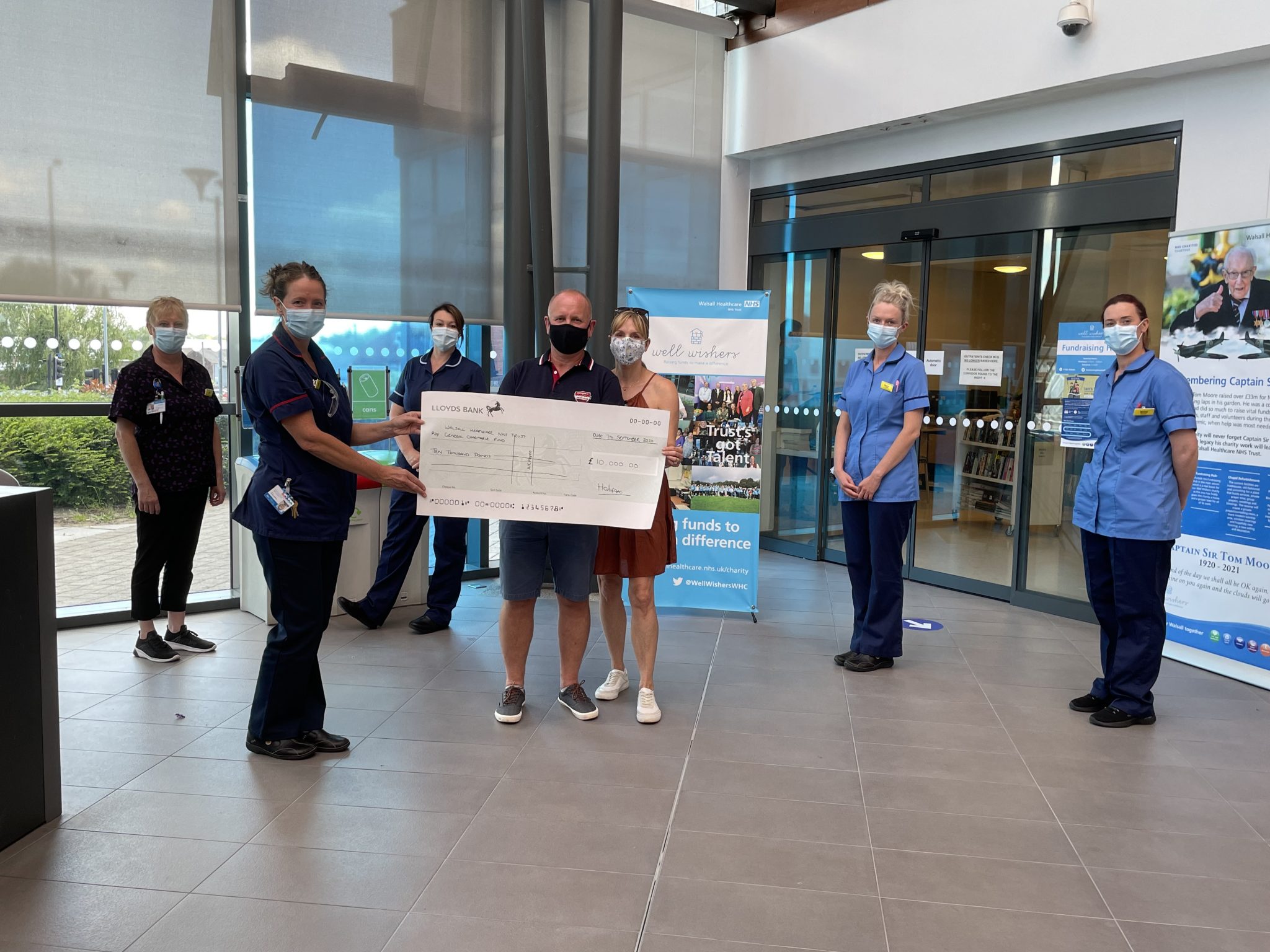 Ian and family hand over a cheque