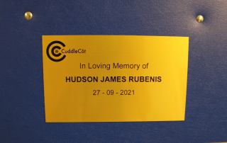 A plaque on the cuddle cot in Hudson's memory
