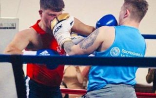 Two boxers in the ring at the charity event