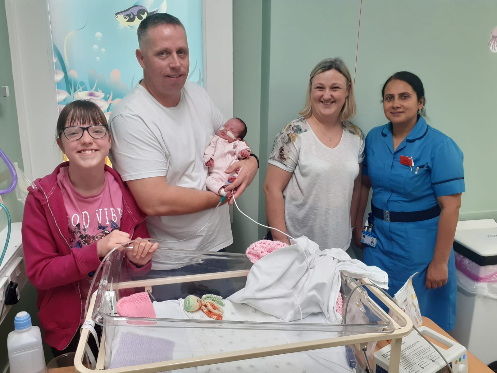 Hollie Kendall with her mum, dad and baby sister Chloe