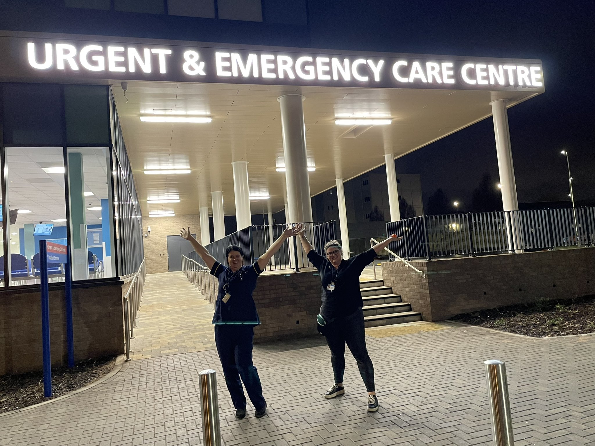 Happy project team leads outside the new entrance