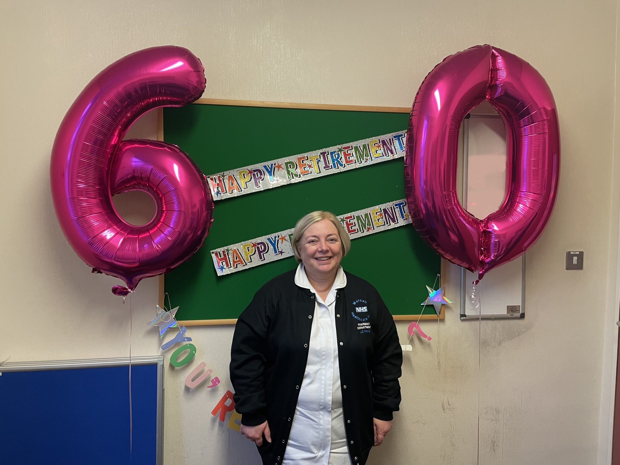 Liz with her 60 birthday balloons and retirement bunting