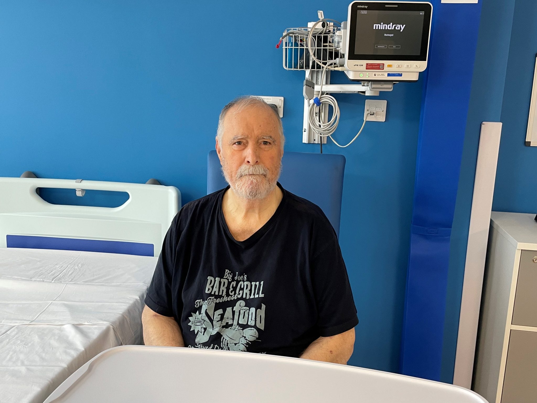 Stephen sat next to his bed in the new acute medical unit (AMU)