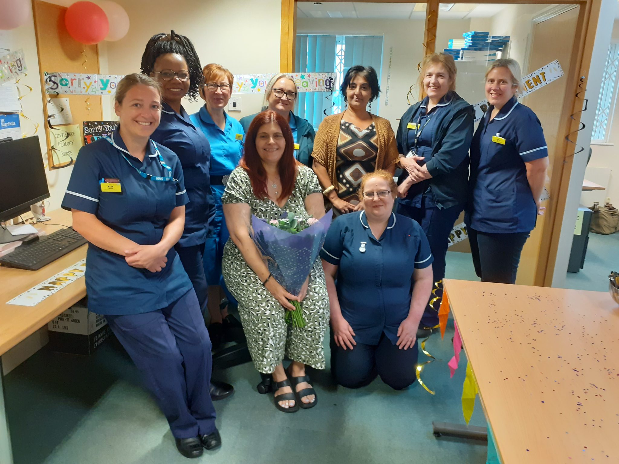 Sue Pardoe is pictured in the middle of her colleagues