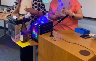 Georgie and Kim with the iPads the charity has bought