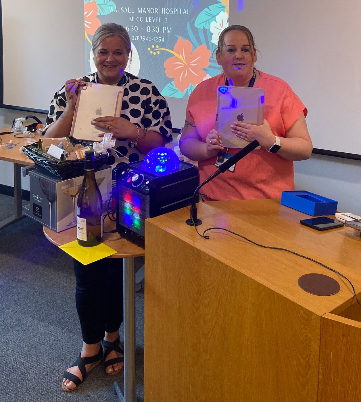 Georgie and Kim with the iPads the charity has bought