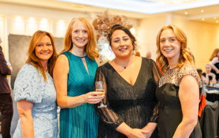 Four staff members smiling at the camera as the celebrate the Caring for All Awards 2025 event.