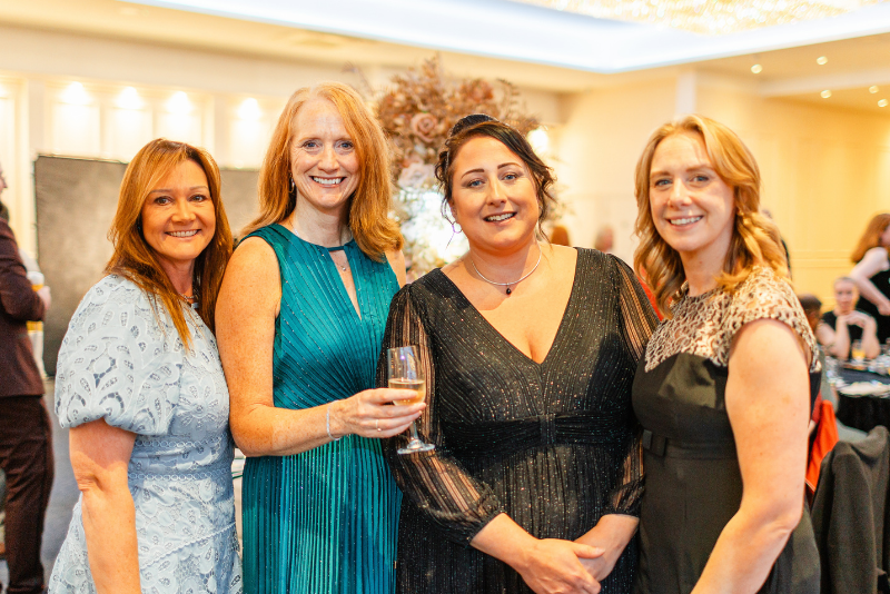 Four staff members smiling at the camera as the celebrate the Caring for All Awards 2025 event.