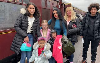 Patient Mila (pictured at front in grey coat) and family