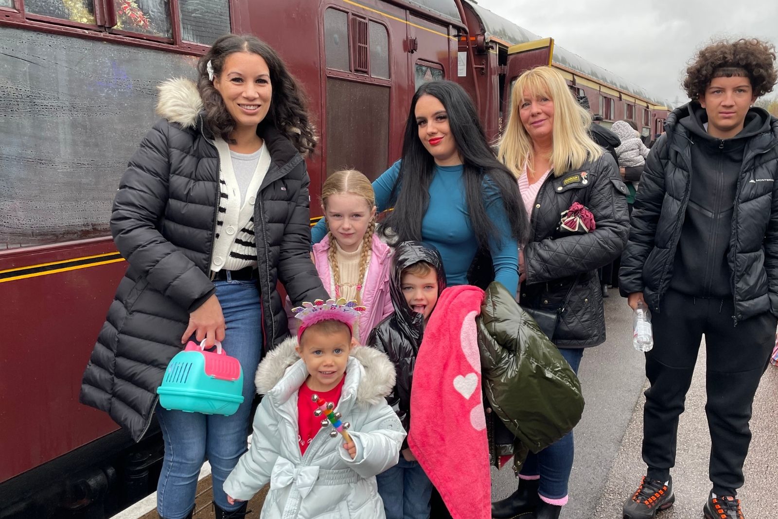 Patient Mila (pictured at front in grey coat) and family