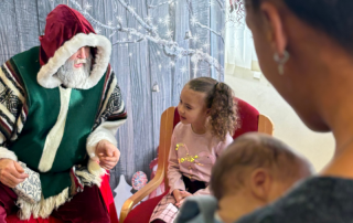 Mum Jade Gardner and baby son Neo and daughter Kya meet Santa at Neonatal Outreach party.
