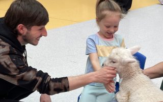 Patient Harlow with a baby lamb.