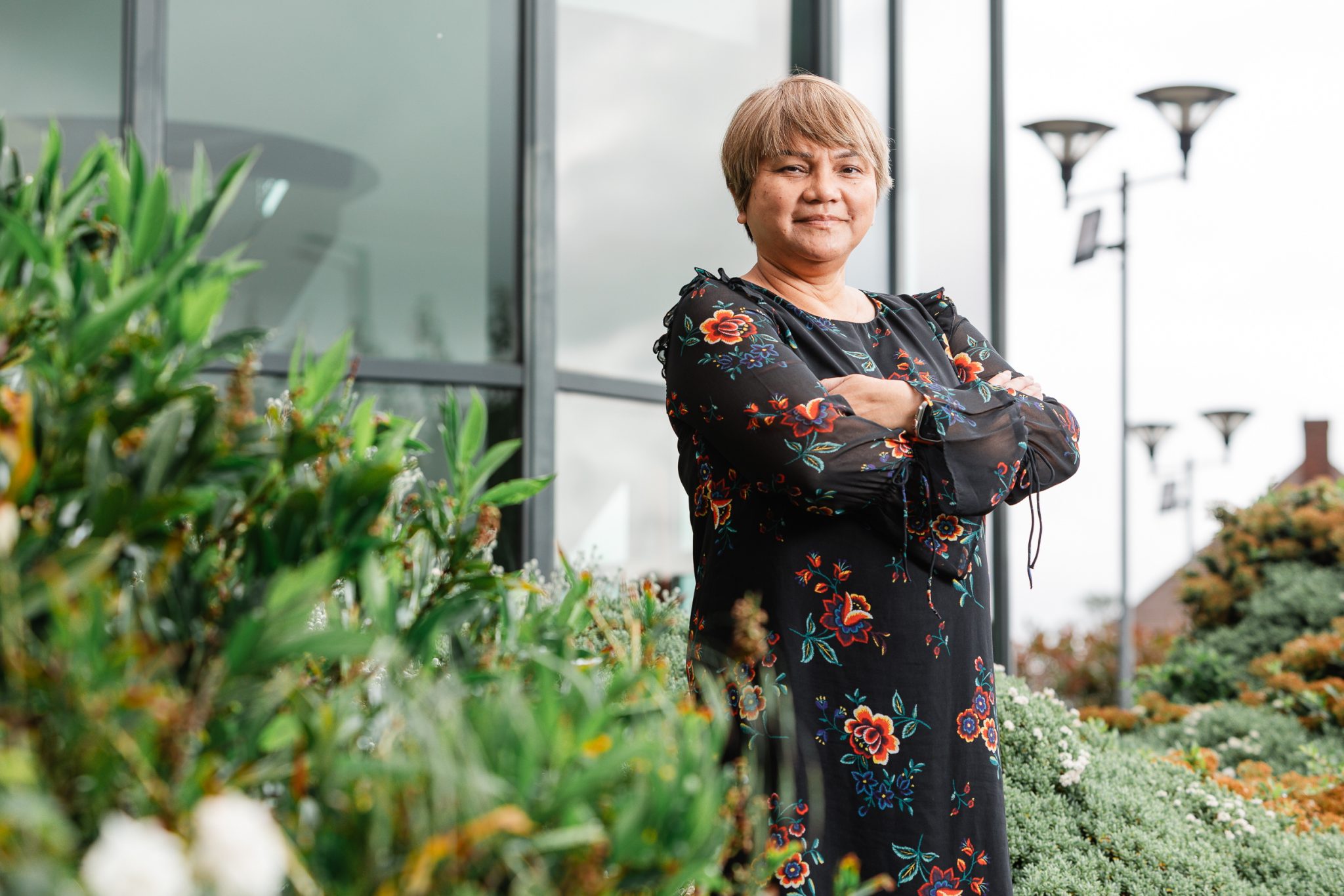 Janet Smith, Head of Sustainability, surrounded by nature outside Walsall Manor Hospital.